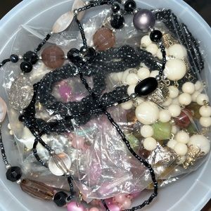 Bucket full of accessories and costume jewelry